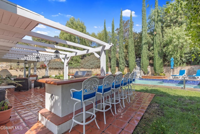 view of patio / terrace with an outdoor kitchen, a pergola, exterior bar, and grilling area