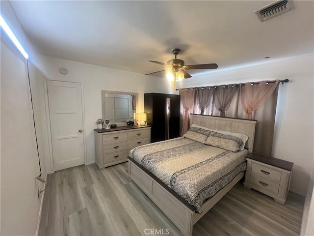 bedroom featuring ceiling fan and light hardwood / wood-style flooring