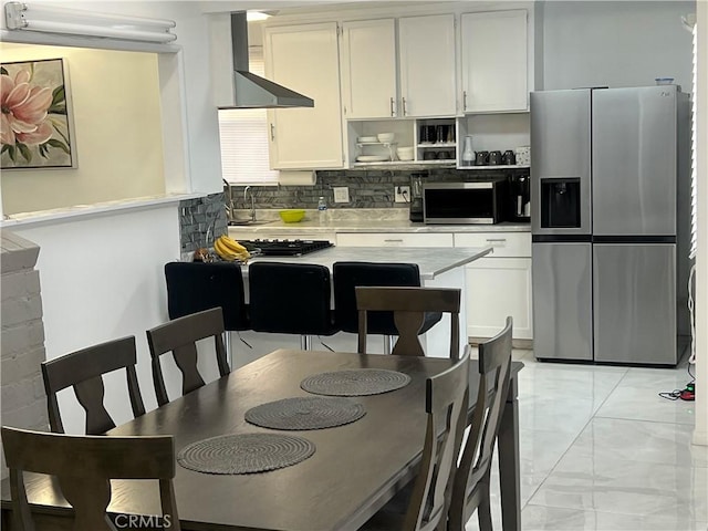 kitchen featuring decorative backsplash, appliances with stainless steel finishes, white cabinetry, and sink