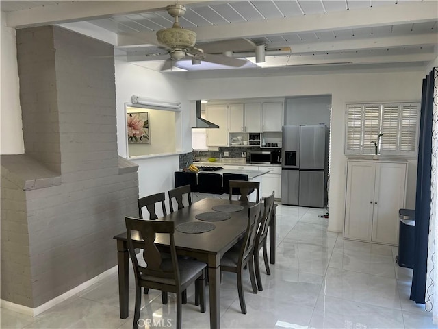 dining space with beamed ceiling, ceiling fan, and wood ceiling