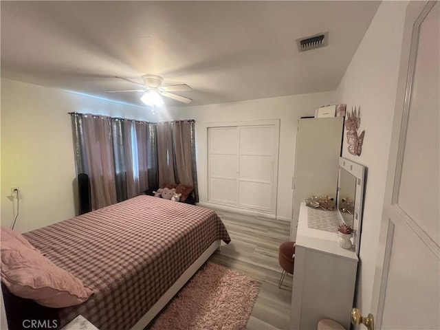 bedroom featuring light hardwood / wood-style flooring and ceiling fan