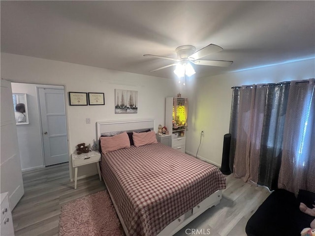 bedroom with ceiling fan and wood-type flooring