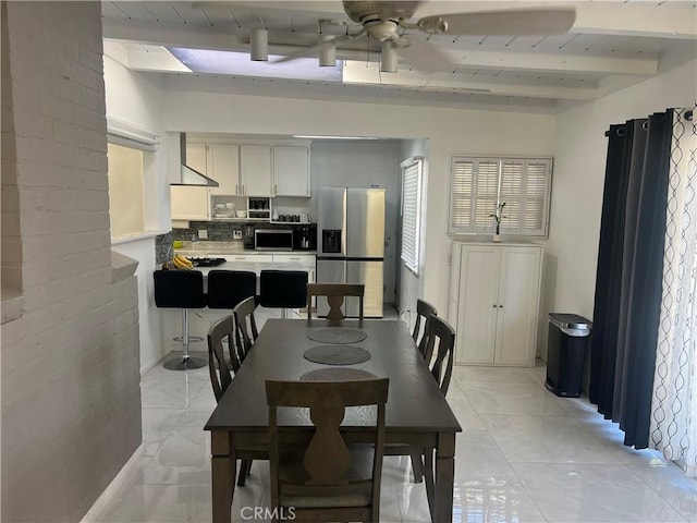 dining room with beam ceiling and ceiling fan