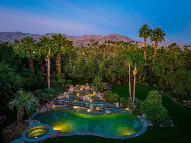 pool at dusk with a mountain view