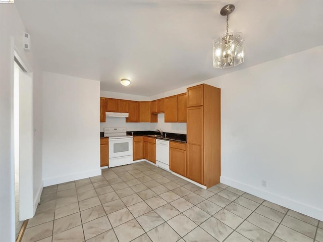 kitchen with an inviting chandelier, decorative light fixtures, sink, and white appliances