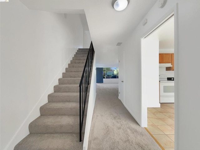 stairway with tile patterned flooring