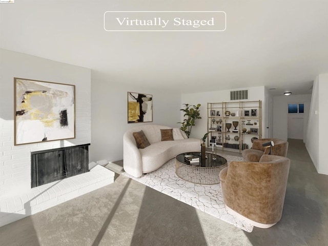 living room featuring concrete flooring and a fireplace