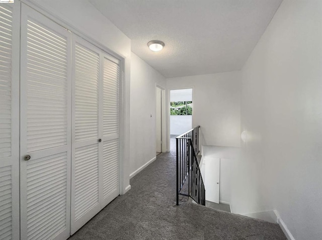 hallway with dark carpet