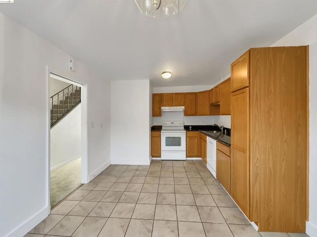 kitchen with light tile patterned floors, sink, and white appliances