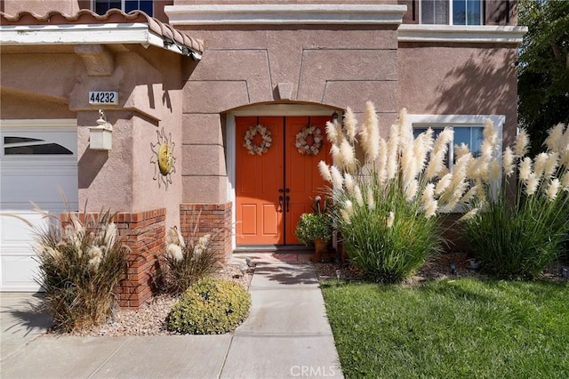 doorway to property with a garage