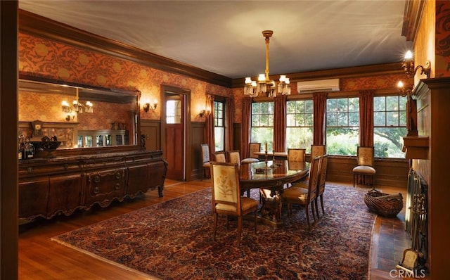 dining area with crown molding, an AC wall unit, dark hardwood / wood-style flooring, and a chandelier