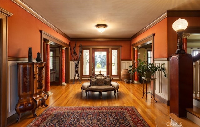 interior space featuring light hardwood / wood-style floors and crown molding