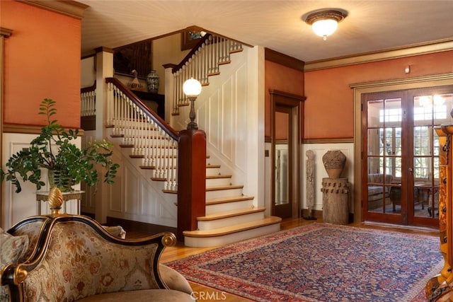 stairway featuring french doors and hardwood / wood-style flooring