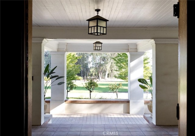 foyer entrance with wood ceiling and light tile patterned flooring