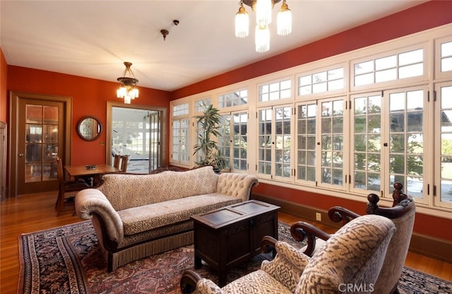 living room featuring plenty of natural light, a chandelier, and hardwood / wood-style flooring