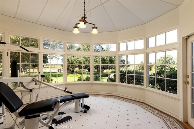 sunroom / solarium featuring a chandelier