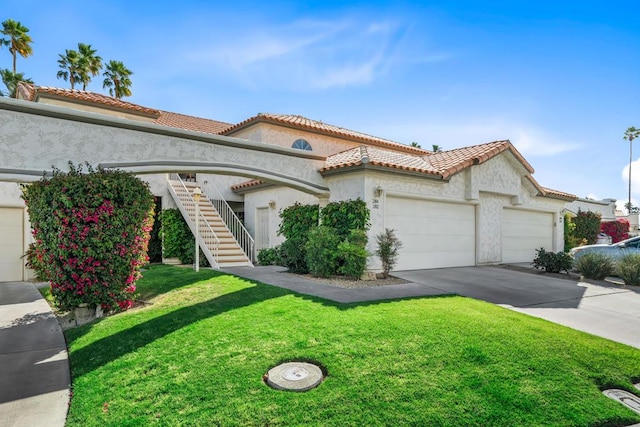 mediterranean / spanish house featuring a front lawn and a garage