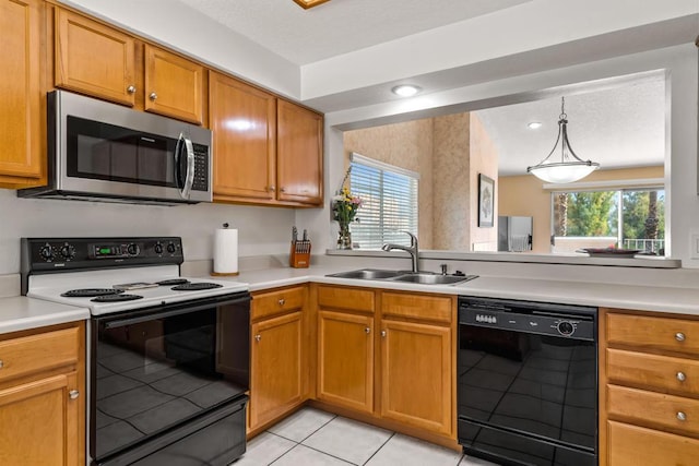 kitchen featuring a healthy amount of sunlight, light tile patterned floors, range with electric cooktop, black dishwasher, and sink