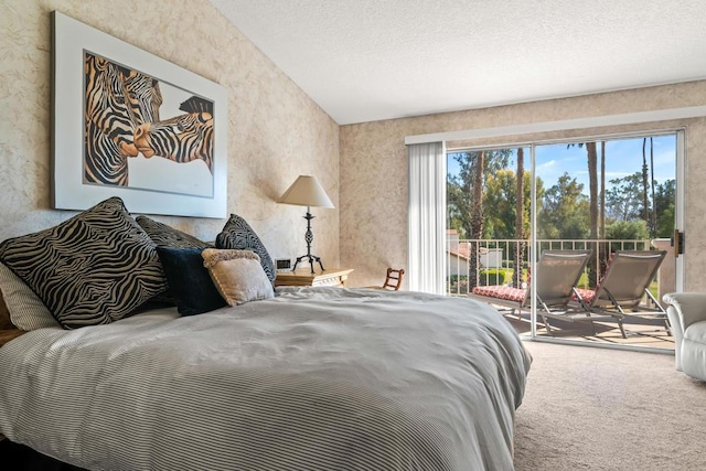 carpeted bedroom featuring lofted ceiling, a textured ceiling, and access to exterior