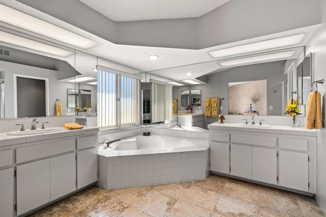 bathroom with a relaxing tiled tub and vanity