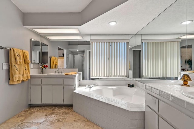 bathroom with shower with separate bathtub and vanity