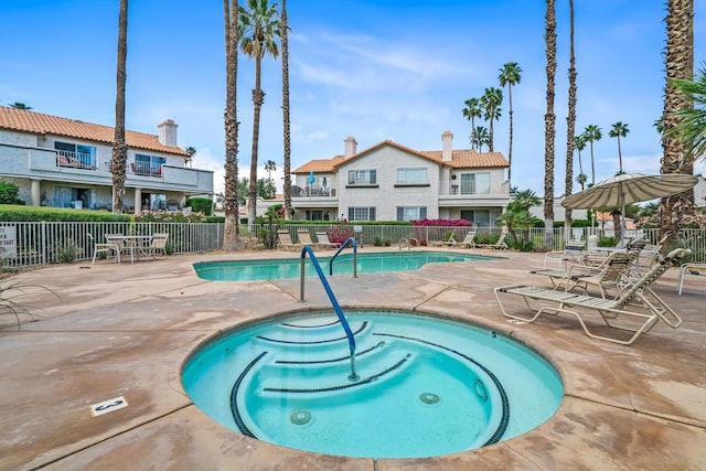 view of swimming pool with a community hot tub and a patio