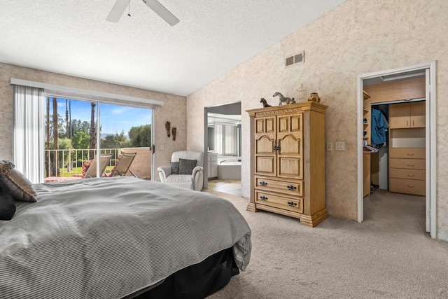 bedroom featuring access to outside, vaulted ceiling, ceiling fan, a walk in closet, and light colored carpet