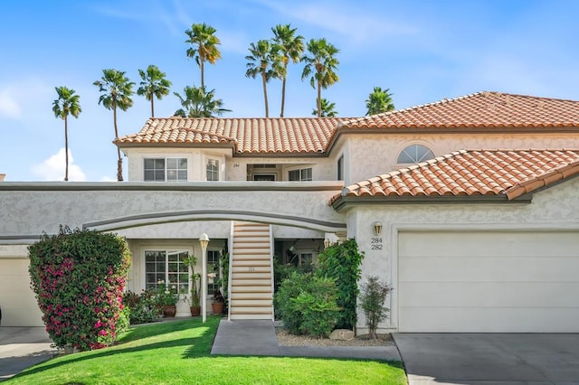 mediterranean / spanish house featuring a front yard