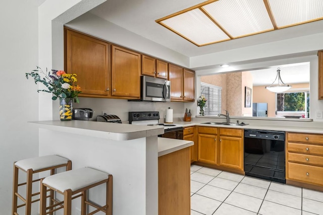 kitchen featuring dishwasher, electric stove, a breakfast bar area, kitchen peninsula, and sink