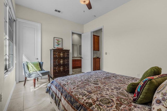 bedroom featuring ceiling fan, ensuite bathroom, and light tile patterned floors