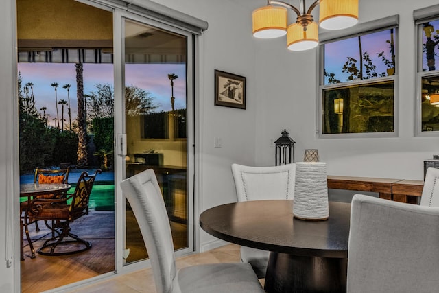 dining space featuring a notable chandelier and light wood-type flooring