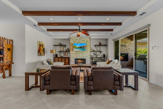 living room with light tile patterned floors, a fireplace, ceiling fan, and beamed ceiling