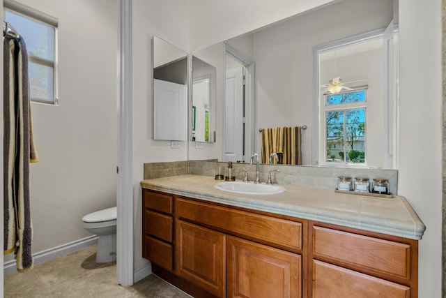 bathroom featuring tile patterned floors, vanity, and toilet