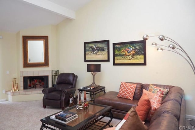 carpeted living room with vaulted ceiling with beams and a tile fireplace