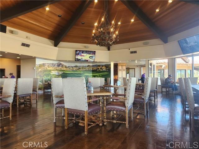 dining area with wooden ceiling, beam ceiling, dark hardwood / wood-style floors, and a chandelier