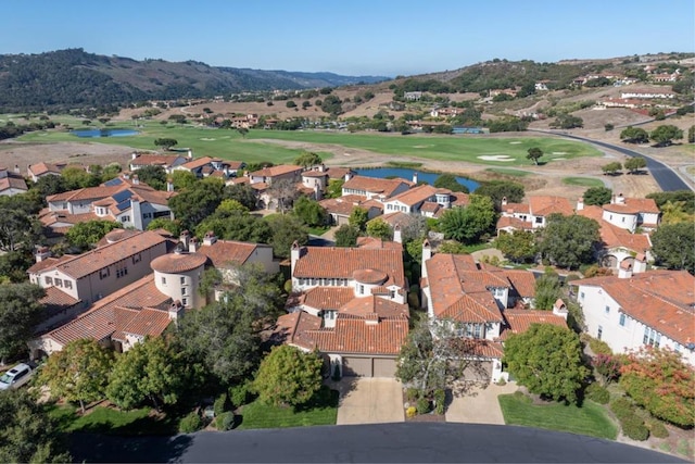 drone / aerial view featuring a water and mountain view