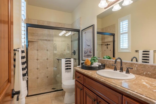 bathroom with a shower with shower door, tile patterned floors, toilet, and vanity