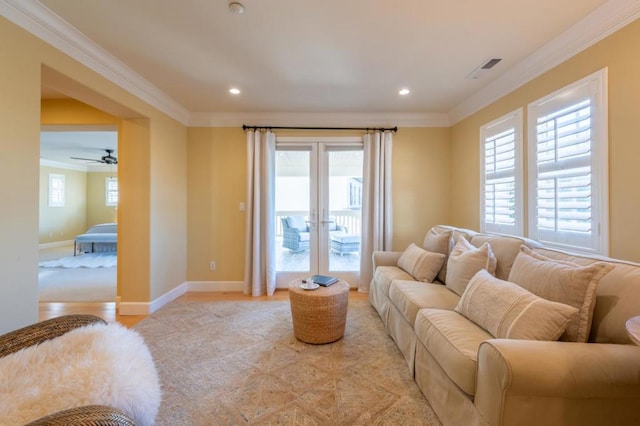 living room featuring ceiling fan and crown molding