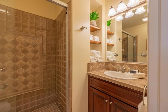 bathroom featuring walk in shower, vanity, and decorative backsplash