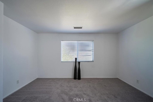 unfurnished room featuring carpet