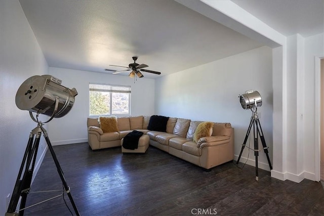 living room with ceiling fan and dark wood-type flooring