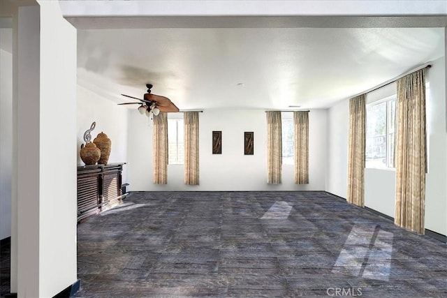 unfurnished living room featuring ceiling fan