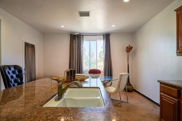 kitchen featuring sink and light tile patterned floors