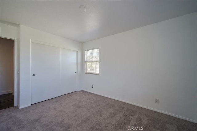 unfurnished bedroom with carpet and a closet