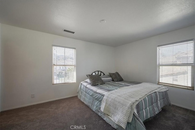 carpeted bedroom featuring multiple windows