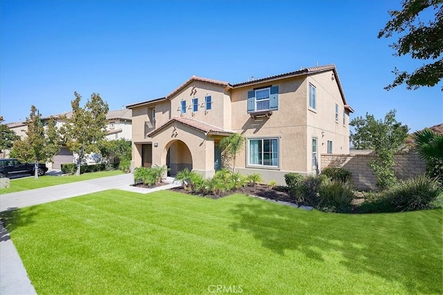 mediterranean / spanish home featuring a front yard