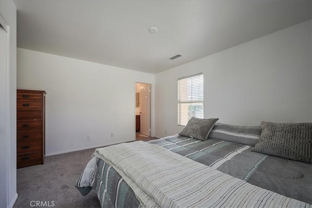 bedroom with carpet floors and ensuite bath