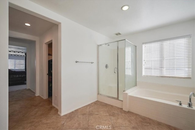 bathroom with tile patterned floors, plenty of natural light, and independent shower and bath