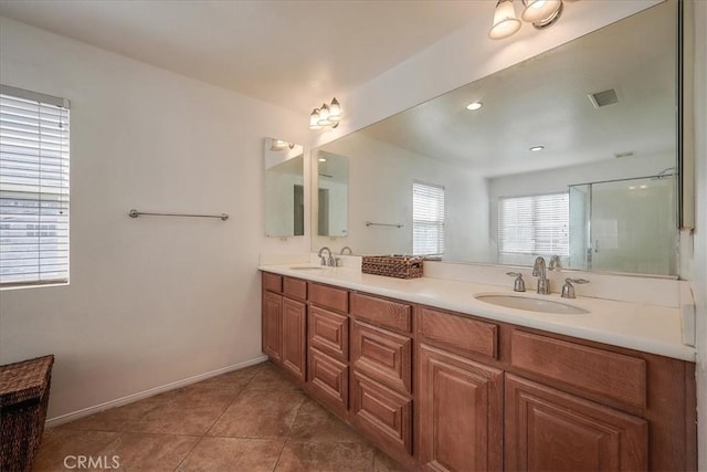 bathroom with tile patterned floors, vanity, and an enclosed shower