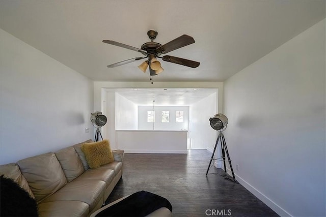 living room featuring ceiling fan and dark hardwood / wood-style flooring